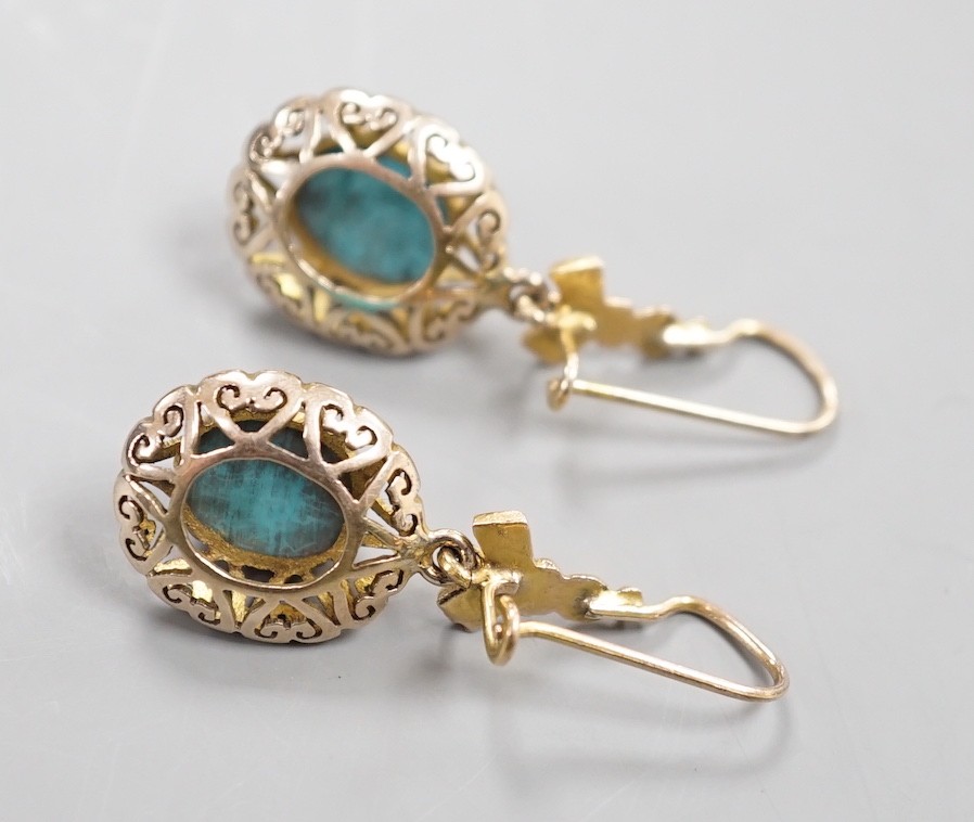 A pair of early 20th century pierced yellow metal and turquoise set drop earrings, 35mm, gross weight 4.3 grams.